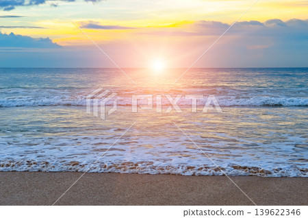 Beautiful Golden Sunset Over Calm Ocean Waves on a Sandy Beach Beautiful Golden Sunset Over Calm Ocean Waves on a Sandy Beach 139622346