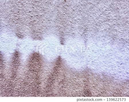 abstract brown spill stain forming intricate pattern on plush beige shag carpet macro closeup texture abstract brown spill stain forming intricate pattern on plush beige shag carpet macro closeup texture 139622573