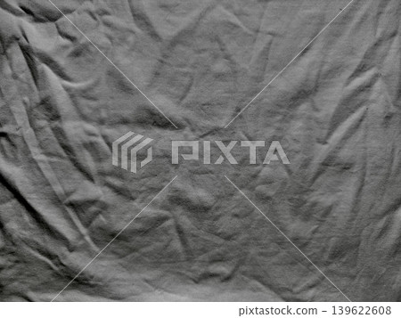 wrinkled gray cotton fabric closeup texture with soft folds shadows minimalist abstract background evoking calm tactile serenity wrinkled gray cotton fabric closeup texture with soft folds shadows minimalist abstract background evoking calm tactile serenity 139622608