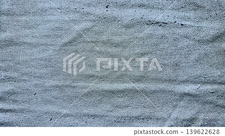 faded indigo denim texture closeup with diagonal twill weave and subtle abrasions evoking vintage casual wear 139622628