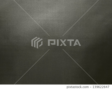 metal mesh texture with fine diagonal weave creating dark industrial background and minimal moody surface detail 139622647