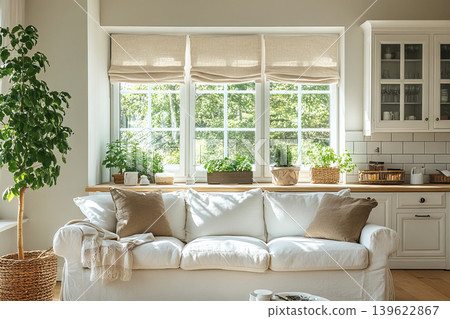 Bright white kitchen interior with cozy sofa and abundant natural light on sunny day Bright white kitchen interior with cozy sofa and abundant natural light on sunny day 139622867