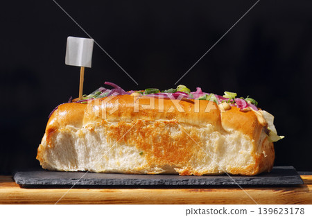 Gourmet loaded street food sandwich on dark slate board Gourmet loaded street food sandwich on dark slate board 139623178