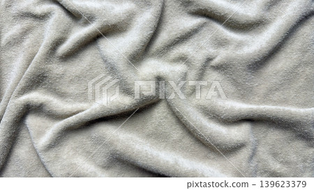 plush fleece blanket texture undulates with cozy rumpled folds and luxurious velvety wrinkles in neutral beige tones plush fleece blanket texture undulates with cozy rumpled folds and luxurious velvety wrinkles in neutral beige tones 139623379