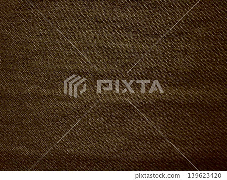brown denim twill fabric macro texture revealing intricate diagonal weave pattern subtle tactile crease detail brown denim twill fabric macro texture revealing intricate diagonal weave pattern subtle tactile crease detail 139623420