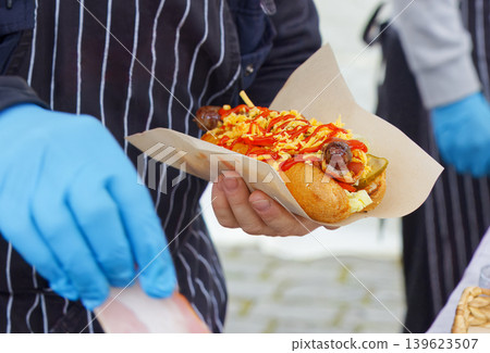 Street food vendor serving loaded hot dog at Naplavka Street food vendor serving loaded hot dog at Naplavka 139623507