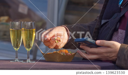 Man Using Smartphone While Eating at Naplavka Man Using Smartphone While Eating at Naplavka 139623530