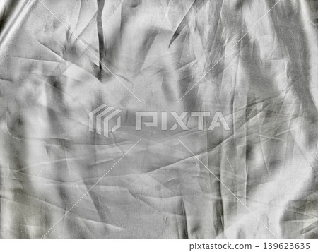 crumpled luminous silk fabric unveils intricate folds with dramatic shadows in abstract monochrome texture crumpled luminous silk fabric unveils intricate folds with dramatic shadows in abstract monochrome texture 139623635