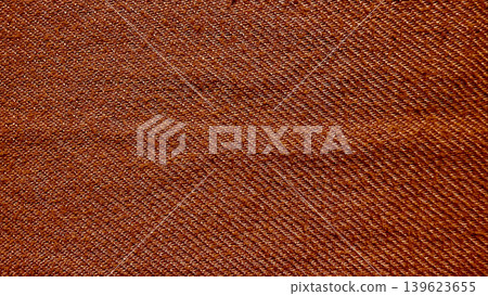 brown denim twill fabric macro closeup reveals intricate diagonal weave in warm earthy rustic texture 139623655