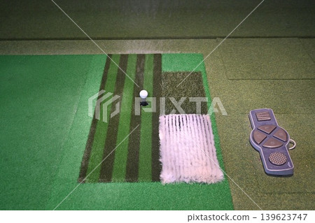 Indoor Golf Simulator Mat with Ball on Tee and Control Panel Indoor Golf Simulator Mat with Ball on Tee and Control Panel 139623747