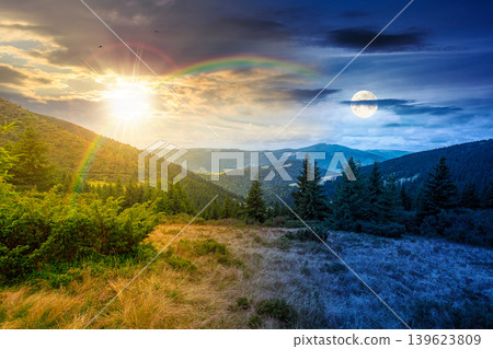 hillside of mountain range with coniferous forest and grassy meadow. day meet night. sun and moon over beautiful summer landscape with alp. wonderful nature background of highland for earth day hillside of mountain range with coniferous forest and grassy meadow. day meet night. sun and moon over beautiful summer landscape with alp. wonderful nature background of highland for earth day 139623809