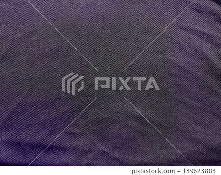 deep purple denim fabric closeup captures intricate weave wrinkles subtle shadows textured macro detail deep purple denim fabric closeup captures intricate weave wrinkles subtle shadows textured macro detail 139623883