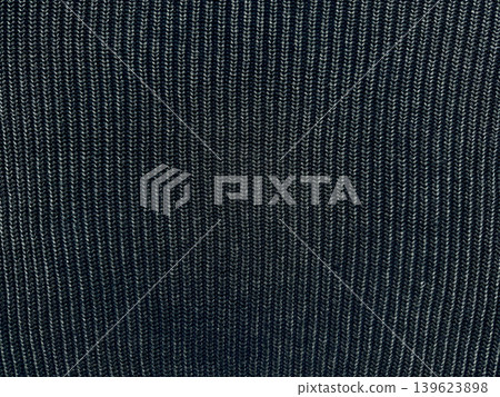 dark ribbed knit fabric texture with vertical ridges intricate stitches and cozy tactile atmosphere in deep tones dark ribbed knit fabric texture with vertical ridges intricate stitches and cozy tactile atmosphere in deep tones 139623898