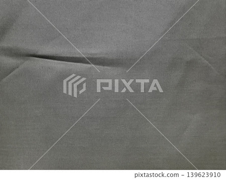softly folded gray woven fabric reveals intricate natural texture and subtle horizontal crease in calm minimalist view softly folded gray woven fabric reveals intricate natural texture and subtle horizontal crease in calm minimalist view 139623910