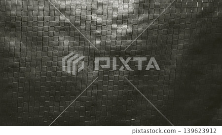 dramatic shadows cast across intricate monochrome woven mesh grid texture in abstract high contrast macro closeup dramatic shadows cast across intricate monochrome woven mesh grid texture in abstract high contrast macro closeup 139623912