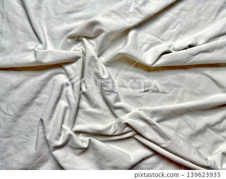 crumpled white linen fabric drapes into soft natural folds with wrinkles and subtle shadows evoking serene comfort crumpled white linen fabric drapes into soft natural folds with wrinkles and subtle shadows evoking serene comfort 139623935