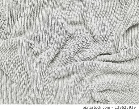 cozy rumpled cable knit sweater fabric softly folded with intricate ribbed patterns evoking warm tactile comfort cozy rumpled cable knit sweater fabric softly folded with intricate ribbed patterns evoking warm tactile comfort 139623939