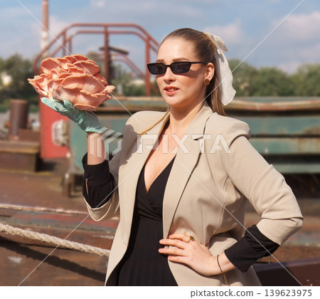 Stylish female vendor holding pink oyster mushrooms at market Stylish female vendor holding pink oyster mushrooms at market 139623975