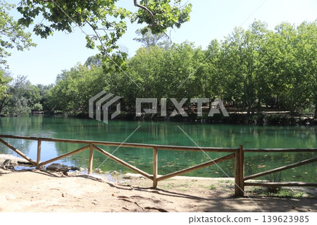Wooden Fence Overlooking the Turquoise Waters of Anna Lake, Spain Wooden Fence Overlooking the Turquoise Waters of Anna Lake, Spain 139623985
