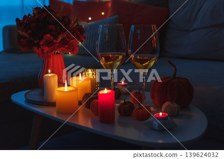 Cozy evening scene with candles, wine glasses and warm candle lighting. Cozy evening scene with candles, wine glasses and warm candle lighting. 139624032
