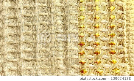 luxurious cream and gold woven fabric texture showcasing intricate metallic diamond patterns in detailed macro closeup luxurious cream and gold woven fabric texture showcasing intricate metallic diamond patterns in detailed macro closeup 139624128