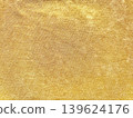 golden woven fabric texture closeup revealing intricate shimmering threads in luxurious warm yellow hues 139624176