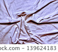 crumpled white fabric with twisted intricate folds soft sensual shadows creating serene minimalist texture closeup 139624183