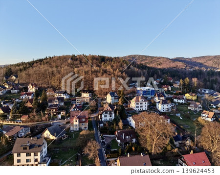 Scenic Hilltop With Autumn Hues. Sunkissed Hilltop Settlement With Cozy Streets And Vibrant Gardens Scenic Hilltop With Autumn Hues. Sunkissed Hilltop Settlement With Cozy Streets And Vibrant Gardens 139624453