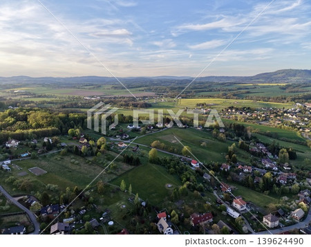 Scattered Homes On Rolling Landscapes. Wide Aerial Shot Of Dispersed Residences And Agricultural Areas Scattered Homes On Rolling Landscapes. Wide Aerial Shot Of Dispersed Residences And Agricultural Areas 139624490