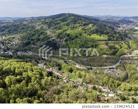 Scenic Settlement Amid Lush Landscapes. Settlement Surrounded By Verdant Hills And Open Fields Scenic Settlement Amid Lush Landscapes. Settlement Surrounded By Verdant Hills And Open Fields 139624521