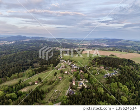 Village At Sunset. Peaceful Hilltop Settlement Showcasing Cultivated Land And Warm Evening Light 139624534