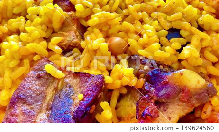 Savor the delectable flavors of Yellow Rice paired beautifully with Chicken and Chickpeas Savor the delectable flavors of Yellow Rice paired beautifully with Chicken and Chickpeas 139624560