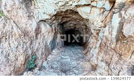 Embarking on a fascinating journey to explore an ancient underground tunnel filled with intrigue Embarking on a fascinating journey to explore an ancient underground tunnel filled with intrigue 139624577
