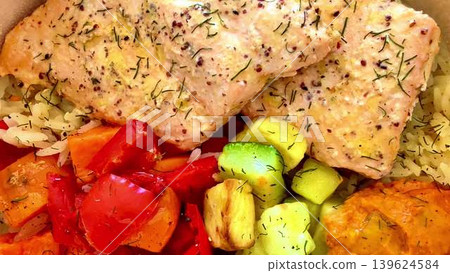 A simply delicious and healthy Salmon Bowl filled with colorful vegetables and fluffy rice 139624584