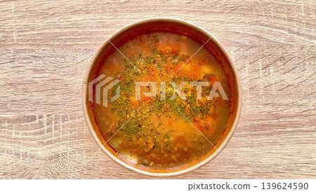Delicious and Hearty Homemade Vegetable Soup in a Bowl Full of Colorful Ingredients Delicious and Hearty Homemade Vegetable Soup in a Bowl Full of Colorful Ingredients 139624590