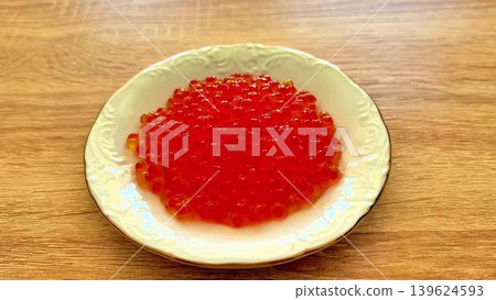 A beautifully arranged plate of fresh red fish caviar, perfect for an elegant dining experience A beautifully arranged plate of fresh red fish caviar, perfect for an elegant dining experience 139624593