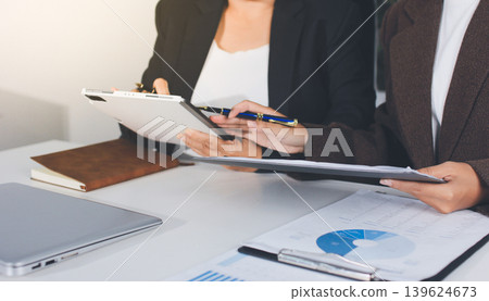 Accountants processing financial documents and taxes, managing corporate finance in a modern office. Audit and taxes in business 139624673