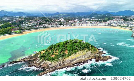 Experience the stunning aerial view of a beautiful coastal island and serene nearby beach 139624702