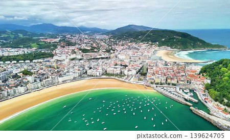 An Aerial View Capturing a Coastal City Featuring a Stunning Beach Alongside a Marina An Aerial View Capturing a Coastal City Featuring a Stunning Beach Alongside a Marina 139624705