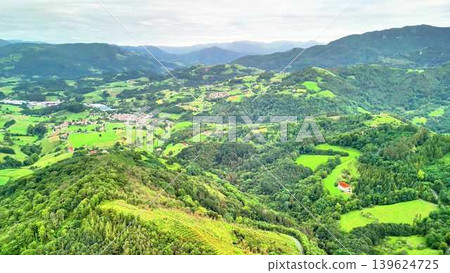 Experience the Stunning Aerial View of Lush Green Hills and Picturesque Villages Below 139624725