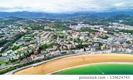 A stunning aerial view showcasing a beautiful scenic coastal city along with its inviting beach 139624743