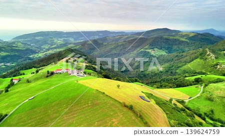 Experience the Breathtaking Aerial View of the Lush Green Mountains and Expansive Fields Experience the Breathtaking Aerial View of the Lush Green Mountains and Expansive Fields 139624759