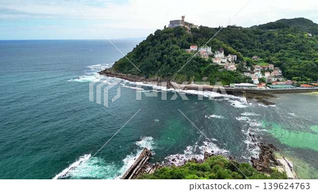 Aerial view of a charming coastal village set against a picturesque ocean landscape 139624763