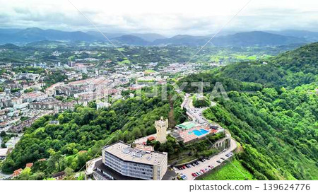 Stunning Aerial View Highlighting the Lush Green Hills Coupled with a Dazzling Cityscape Stunning Aerial View Highlighting the Lush Green Hills Coupled with a Dazzling Cityscape 139624776