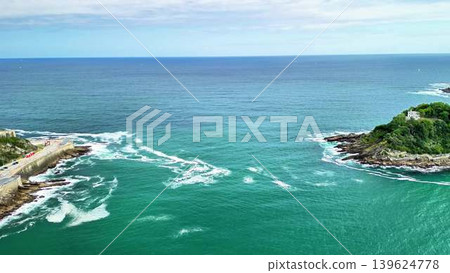 Enjoy serene coastal views with turquoise waters and gentle waves, ideal for relaxation 139624778