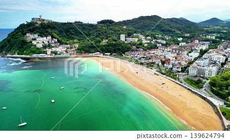 A beautifully scenic aerial view showcasing a stunning beach and picturesque coastal town A beautifully scenic aerial view showcasing a stunning beach and picturesque coastal town 139624794