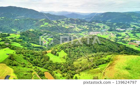 Discover a Breathtaking Aerial View Showcasing Lush Green Hills and Scenic Valleys 139624797