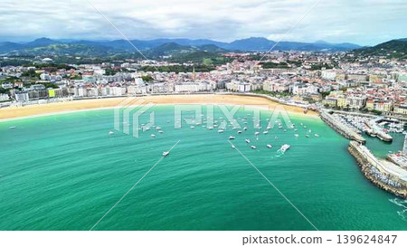A Stunning Aerial View of a Beautiful Coastal Town Featuring Vibrant Waters and Many Boats A Stunning Aerial View of a Beautiful Coastal Town Featuring Vibrant Waters and Many Boats 139624847