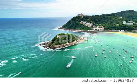 Experience the breathtaking and stunning aerial view of a coastal paradise complete with boats Experience the breathtaking and stunning aerial view of a coastal paradise complete with boats 139624857