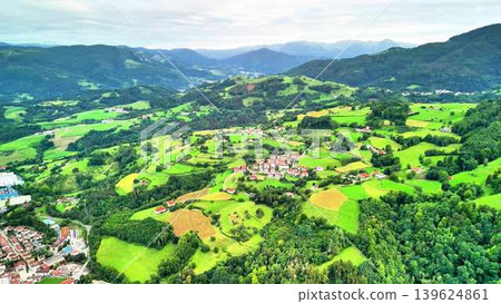 Enjoy this breathtaking aerial view of the lush green landscape and captivating rolling hills 139624861